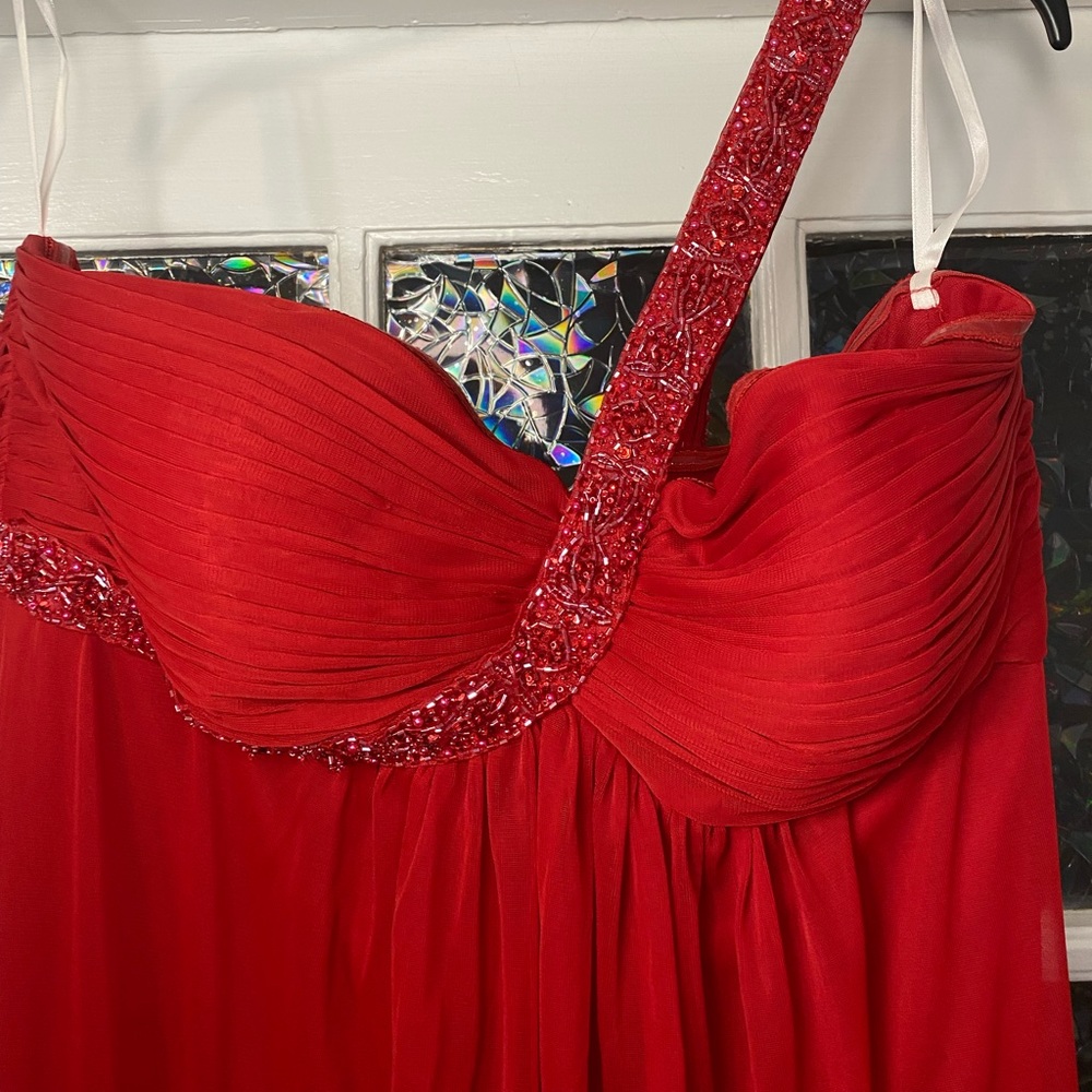 Floor length red prom dress with beaded accent and one shoulder